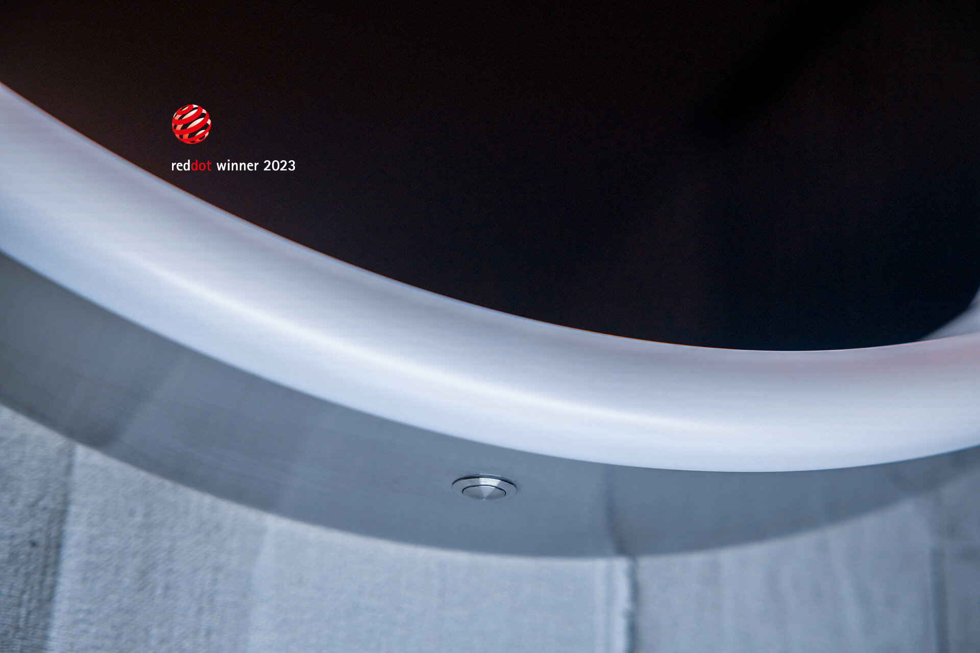 LUNE SP D2W illuminated mirror Light mirror on concrete wall. Detailed view from below with frame and light switch.